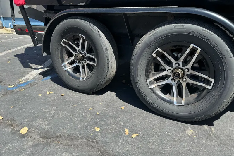 Slide: The Image of 2019 Sanger 212 SL trailer with flat tires in a parking lot. - 9
