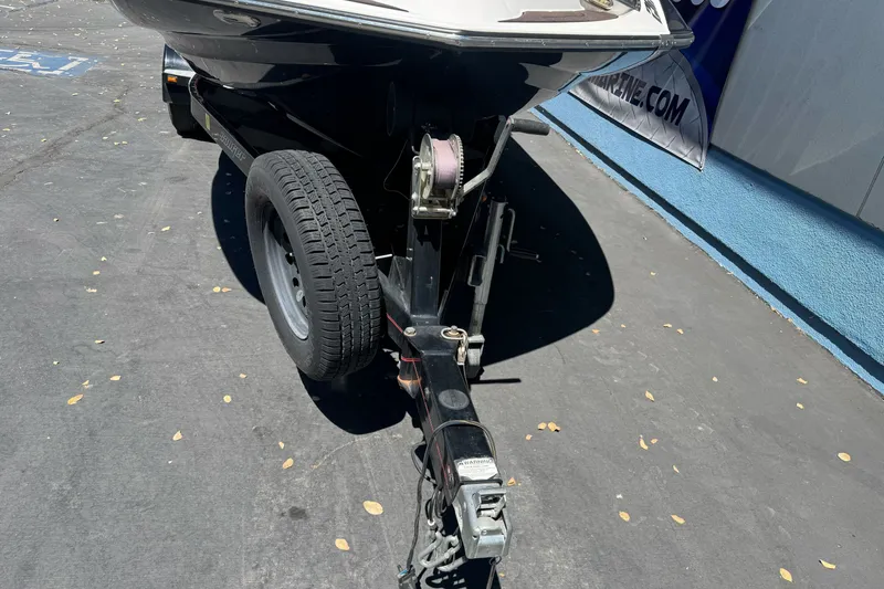 Slide: The Image of 2019 Sanger 212 SL boat trailer hitch and wheel on pavement. - 8