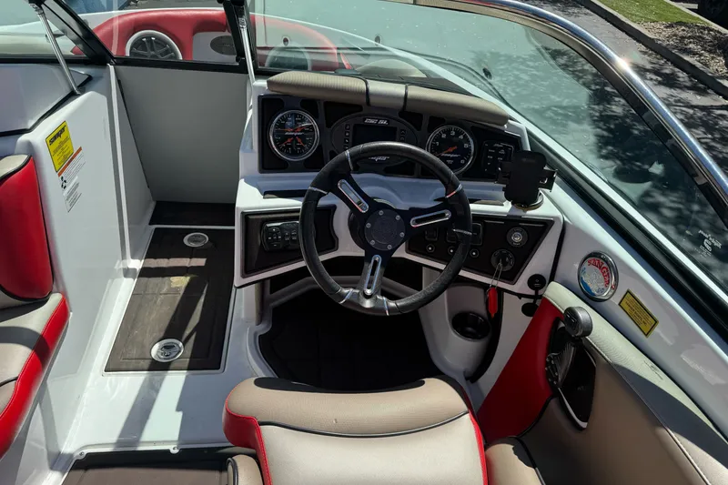 Slide: The Image of Interior view of 2019 Sanger 212 SL boat cockpit with steering wheel and gauges. - 18