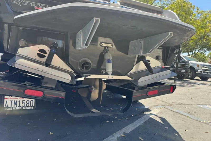 Slide: The Image of Rear view of a 2019 Sanger 212 SL boat on a trailer in a parking lot. - 4