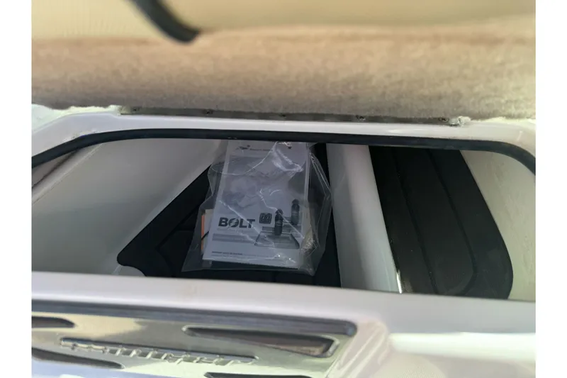 Slide: The Image of Storage compartment in a 2019 Sanger 212 SL boat with a Bolt package inside. - 24
