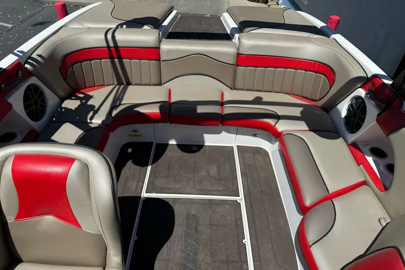 Slide: The Image of Interior of a 2019 Sanger 212 SL boat with red and beige seating. - 13