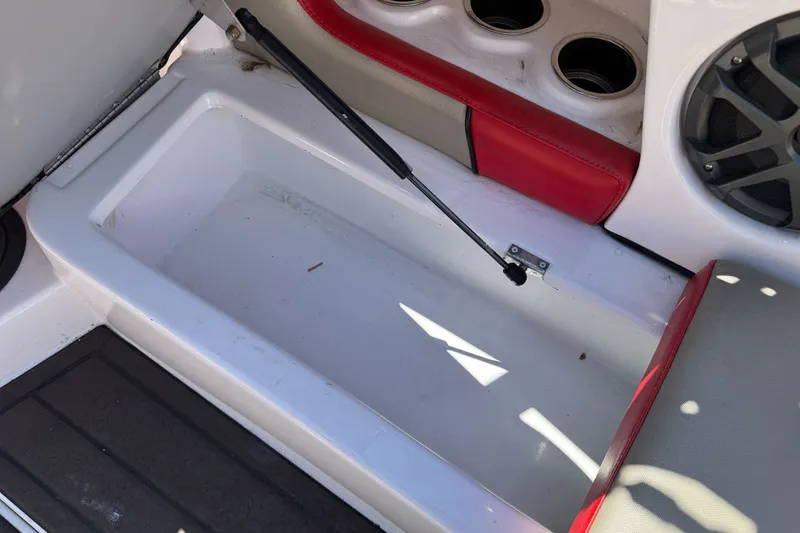 Slide: The Image of Storage compartment in 2019 Sanger 212 SL boat with red and gray seating. - 20