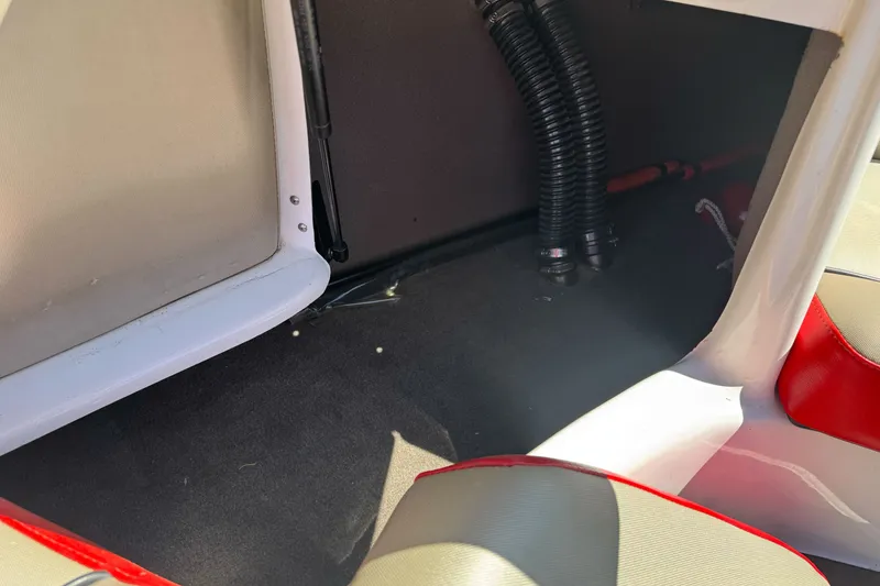 Slide: The Image of Interior view of a 2019 Sanger 212 SL boat, showcasing seating and storage area. - 21