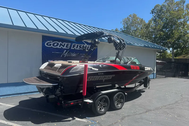 Slide: The Image of 2019 Sanger 212 SL boat on trailer at Gone Fishin' Marine dealership. - 2