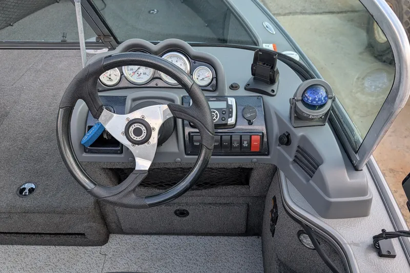 Slide: The Image of Steering console of 2012 Lund 1875 Pro-V IFS boat with gauges and compass. - 5