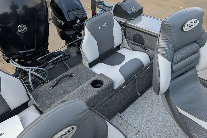 Slide: The Image of 2012 Lund 1875 Pro-V IFS boat interior with seating and Mercury outboard motor. - 7