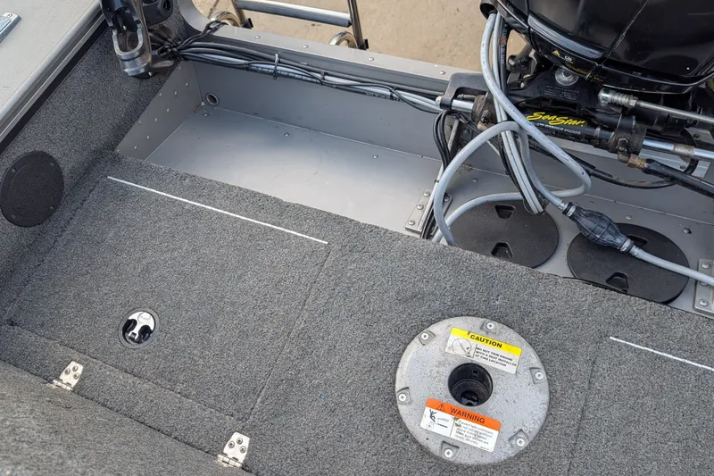 Slide: The Image of Interior view of a 2012 Lund 1875 Pro-V IFS boat, showcasing engine and wiring details. - 15