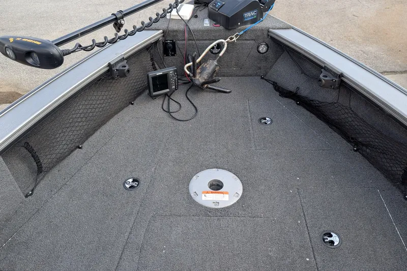 Slide: The Image of 2012 Lund 1875 Pro-V IFS boat interior with fishing equipment and storage compartments. - 8