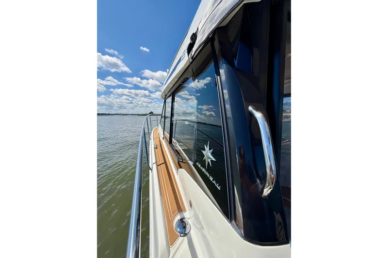 Slide: The Image of 2019 Jeanneau NC 895 boat on calm water under a clear blue sky. - 21