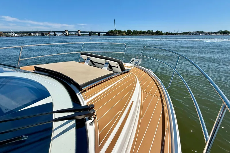 Slide: The Image of 2019 Jeanneau NC 895 boat deck with scenic water view and bridge in background. - 23