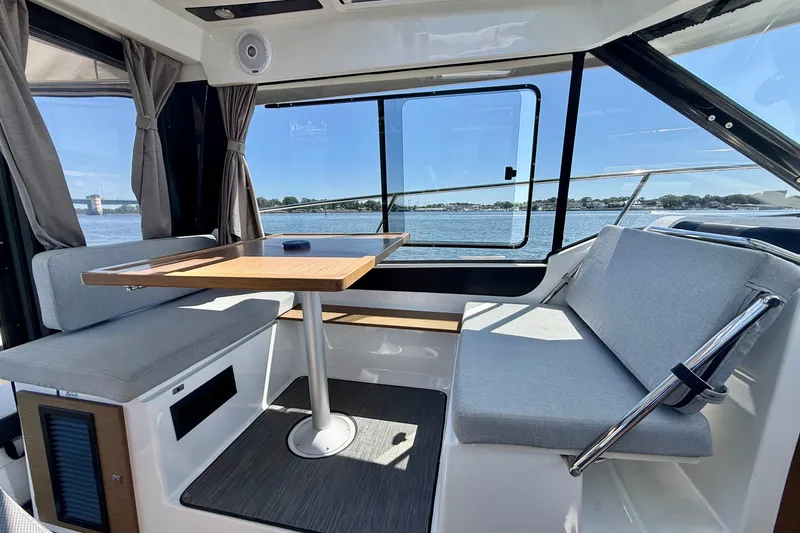 Slide: The Image of Interior of 2019 Jeanneau NC 895 boat with seating and table, overlooking water. - 19