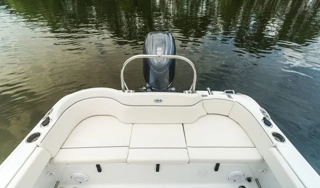 Slide: The Image of The image shows the stern of a Sea Hunt Ultra 229 boat on calm water. - 4