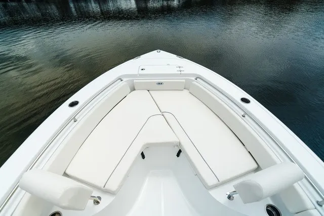 Slide: The Image of The image shows the bow of a 2027 Sea Hunt Ultra 229 boat with white cushions. - 8