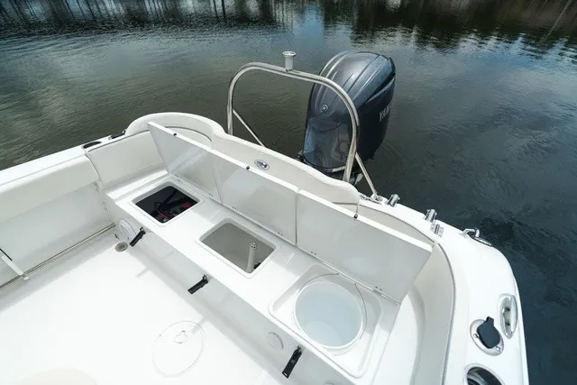Slide: The Image of The image shows the stern of a Sea Hunt Ultra 229 boat with an outboard motor. - 12