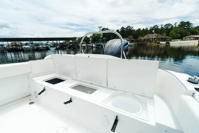 Slide: The Image of The image shows the stern of a Sea Hunt Ultra 229 boat with multiple storage compartments. - 11