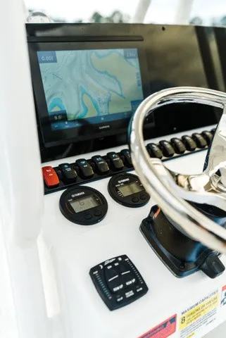 Slide: The Image of The image shows the helm of a Sea Hunt Ultra 229 with a navigation screen and instruments. - 7