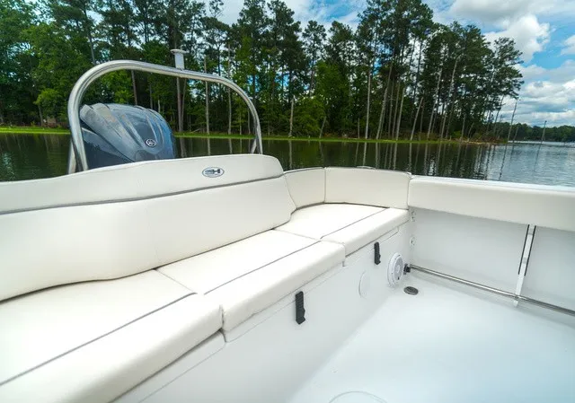 Slide: The Image of The image shows the stern of a Sea Hunt Ultra 229 with white cushions and an outboard motor. - 5