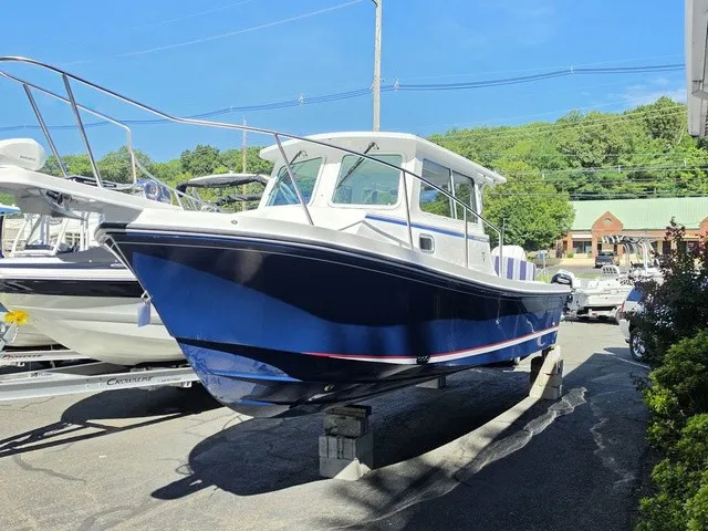The Image of A 2027 Steiger Craft 255 Annapolis boat is parked. It features a blue hull. - 1