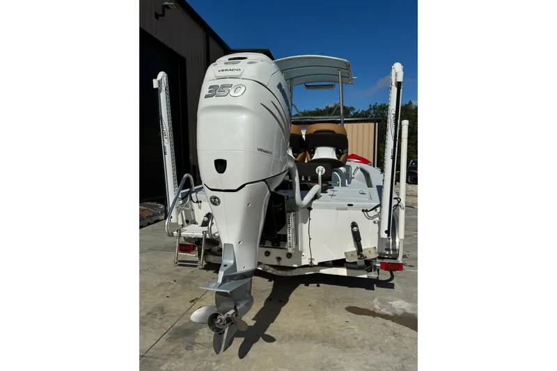 Slide: The Image of 2021 Haynie 25 Magnum boat with powerful Verado 350 outboard motor, parked outdoors. - 17