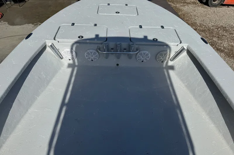 Slide: The Image of 2021 Haynie 25 Magnum boat interior with storage compartments and speakers. - 6