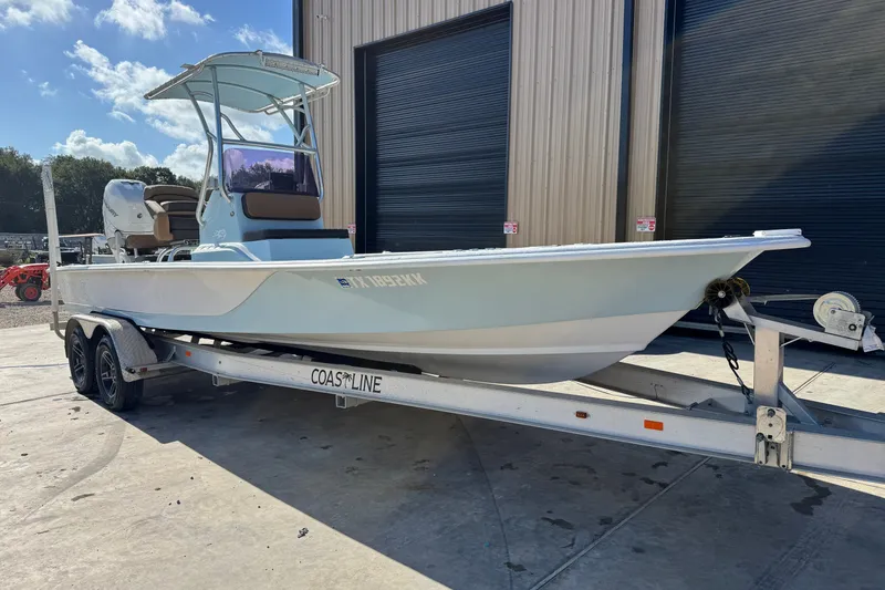Slide: The Image of 2021 Haynie 25 Magnum boat on trailer, parked outside a building. - 3
