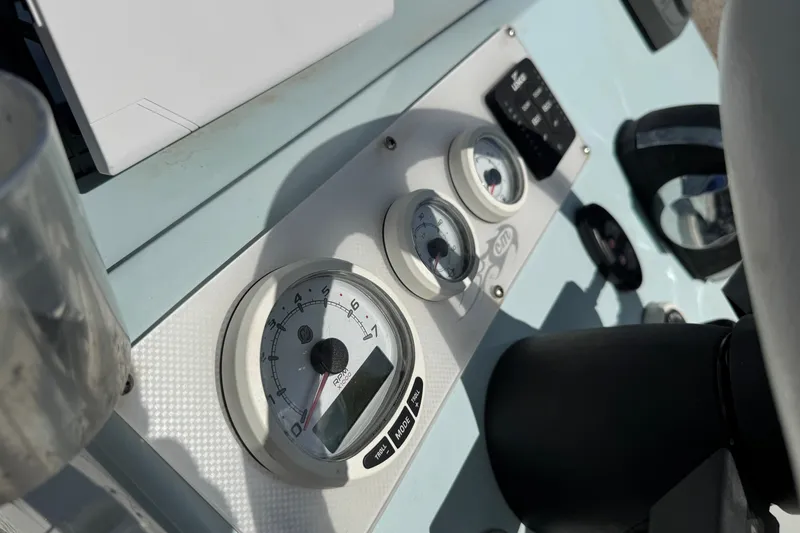 Slide: The Image of Dashboard of a 2021 Haynie 25 Magnum boat with gauges and controls. - 10
