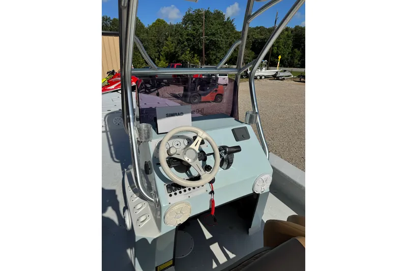 Slide: The Image of 2021 Haynie 25 Magnum boat console with steering wheel and Simrad display. - 9