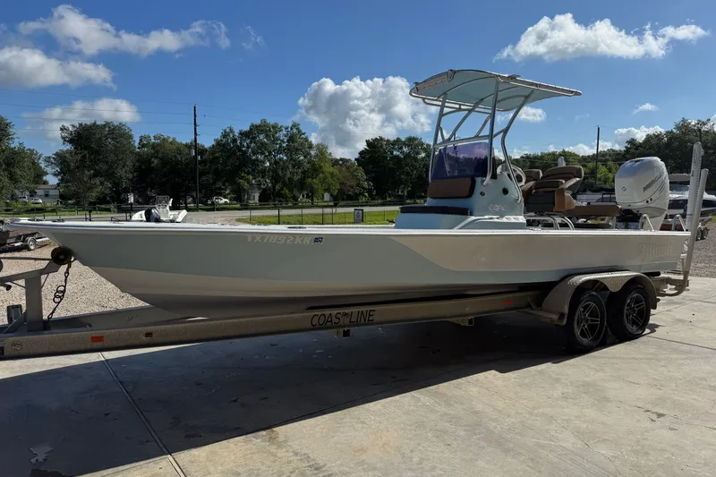 Slide: The Image of 2021 Haynie 25 Magnum boat on trailer under clear sky. - 5