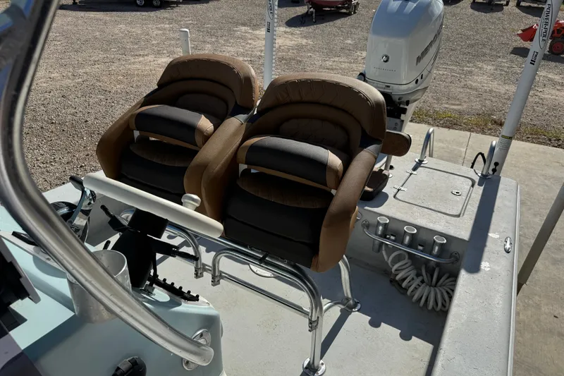 Slide: The Image of 2021 Haynie 25 Magnum boat interior with dual seats and motor. - 11