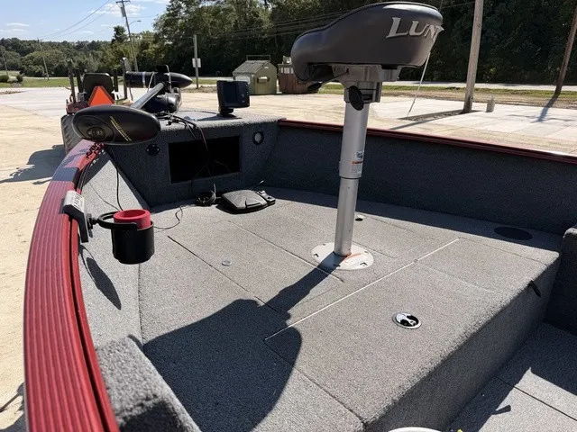 Slide: The Image of The image shows the deck of a 2009 Lund 1625 REBEL XL boat with seating and controls. - 12