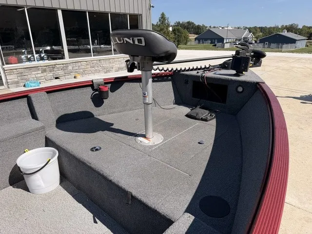 Slide: The Image of The image shows the bow deck of a 2009 Lund 1625 REBEL XL boat with gray carpeting and a seat. - 7