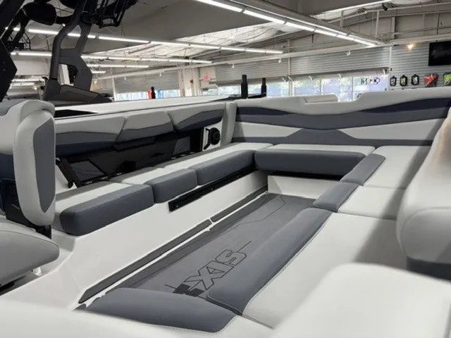 Slide: The Image of The image shows the interior of a 2027 Axis Wake Research A245 boat with gray and white seating. - 9