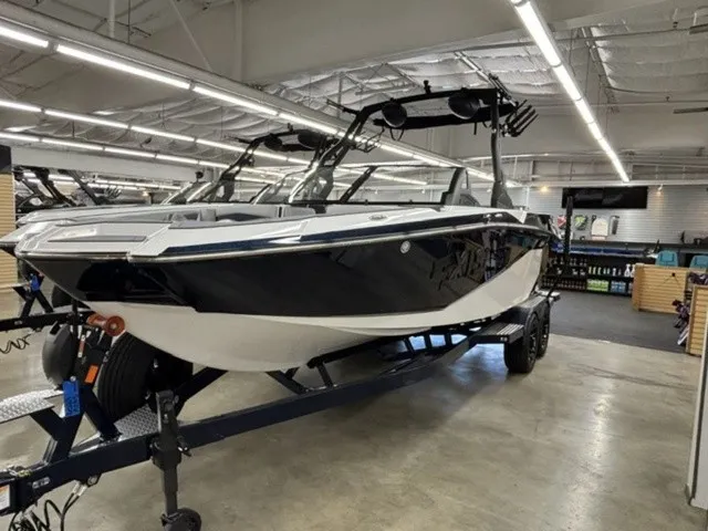 Slide: The Image of A 2027 Axis Wake Research A245 boat on a trailer in a showroom. - 3