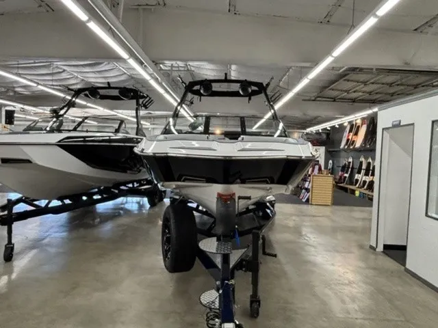 Slide: The Image of A 2027 Axis Wake Research A245 is displayed on a trailer in a showroom. - 4