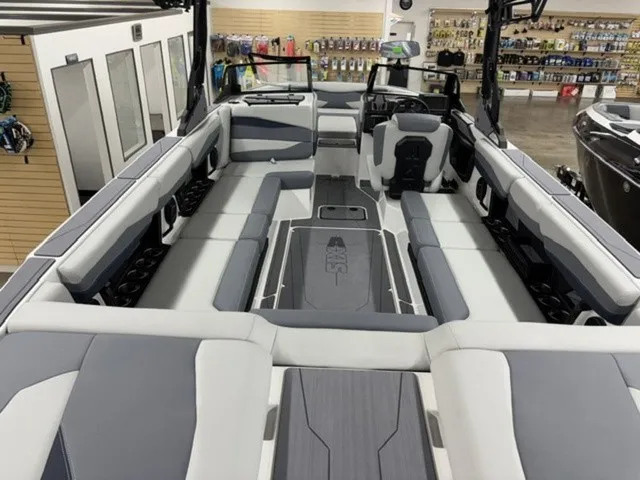 Slide: The Image of The image shows the spacious interior of an Axis Wake Research A245 boat with gray and white seating. - 8