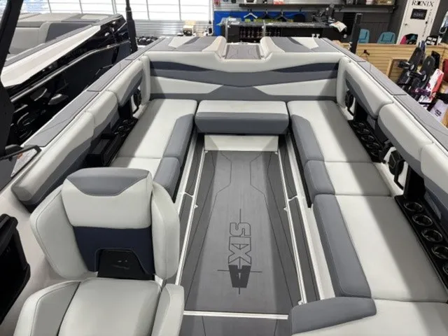 Slide: The Image of The image shows the interior of a 2027 Axis Wake Research A245 boat with gray and white seating. - 6