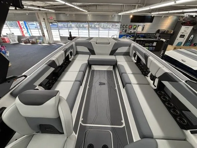 Slide: The Image of The image shows the spacious interior of an Axis Wake Research T250 boat with gray and white seating. - 8