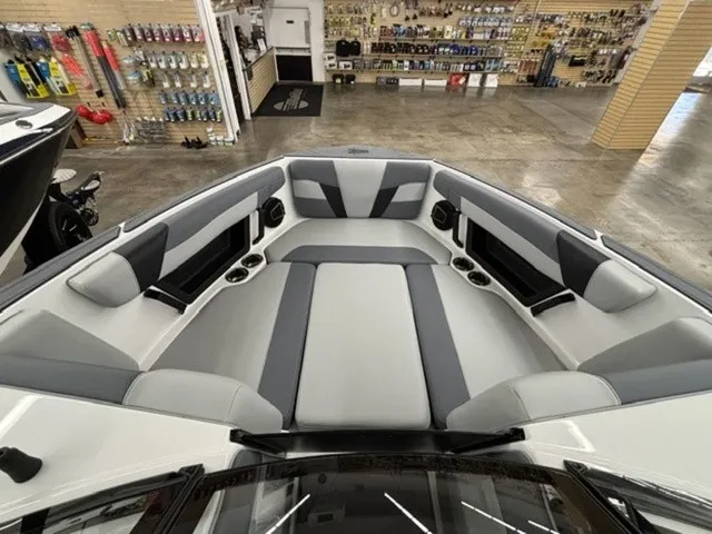 Slide: The Image of The image shows the bow area of a 2027 Axis Wake Research T250 boat with gray upholstery. - 7