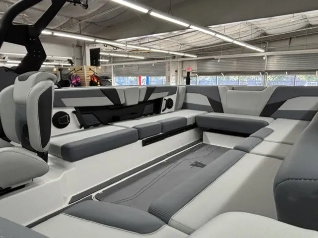 Slide: The Image of The image shows the interior of a 2027 Axis Wake Research T250 boat with gray and white seating. - 12