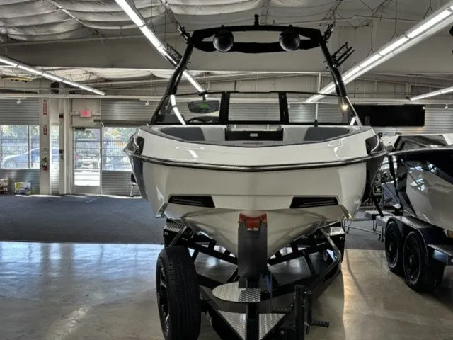 Slide: The Image of A 2027 Axis Wake Research T250 sits on a trailer in a showroom. - 4