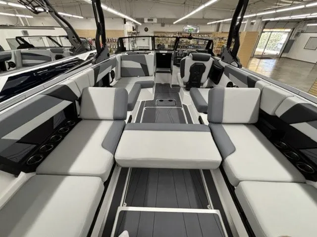 Slide: The Image of The image shows the spacious, modern interior of an Axis Wake Research T250 boat with gray and white seating. - 10