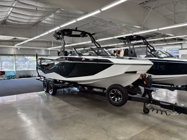 Slide: The Image of A 2027 Axis Wake Research T250 on a trailer in a showroom. - 3