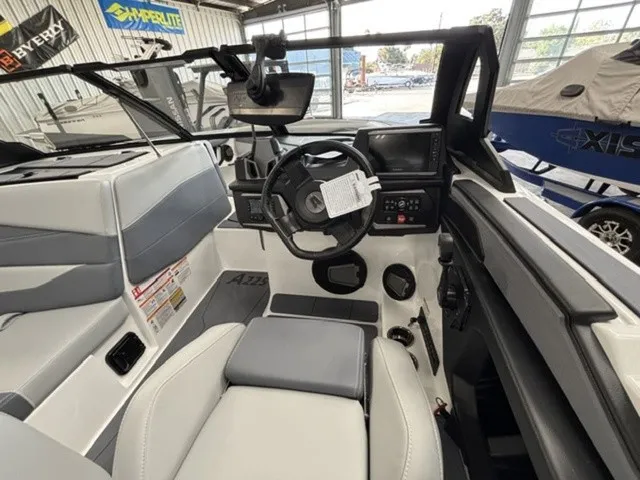 Slide: The Image of Interior of a 2027 Axis Wake Research A225 with modern helm and gray seating. - 10