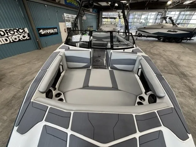 Slide: The Image of The image shows the interior of a 2027 Axis Wake Research A225 boat with gray upholstery. - 7