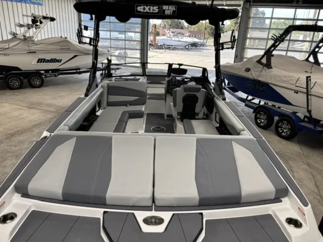 Slide: The Image of The image shows the interior of a 2027 Axis Wake Research A225 boat with gray upholstery. - 5