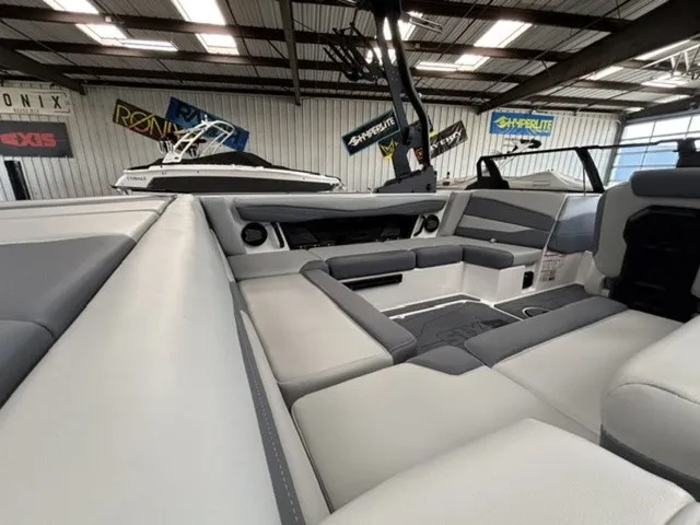 Slide: The Image of The image shows the interior of a 2027 Axis Wake Research A225 boat with gray upholstery. - 8