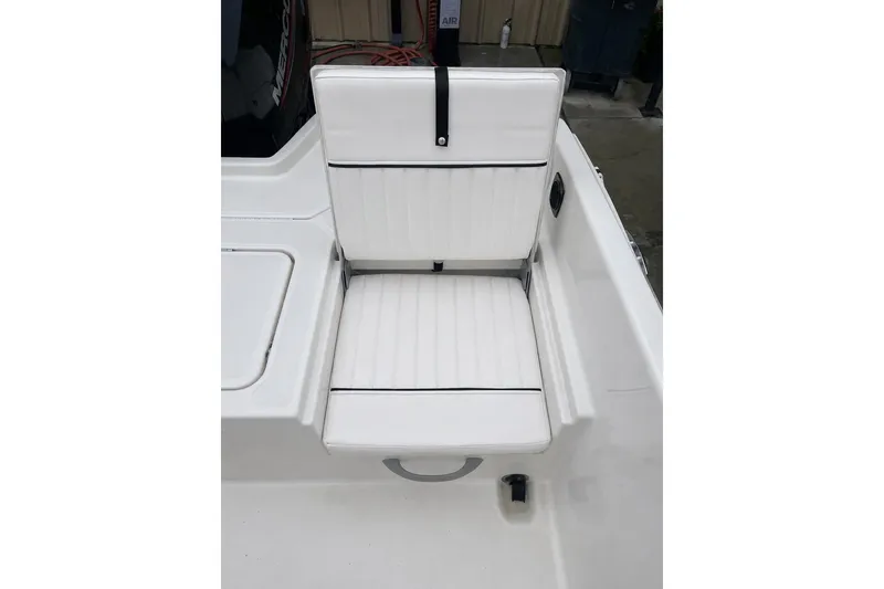 Slide: The Image of White cushioned seat on 2021 Bayliner Element F21 boat, featuring sleek design and comfort. - 8