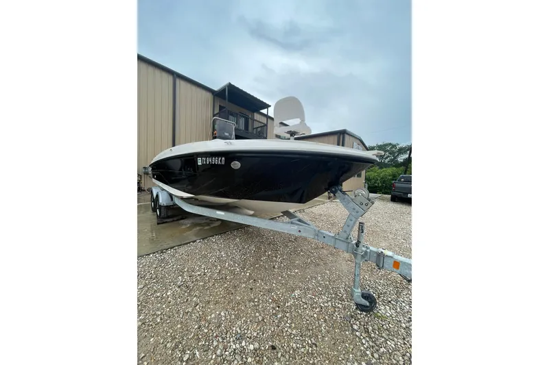 Slide: The Image of 2021 Bayliner Element F21 boat on trailer, parked outside a building. - 4