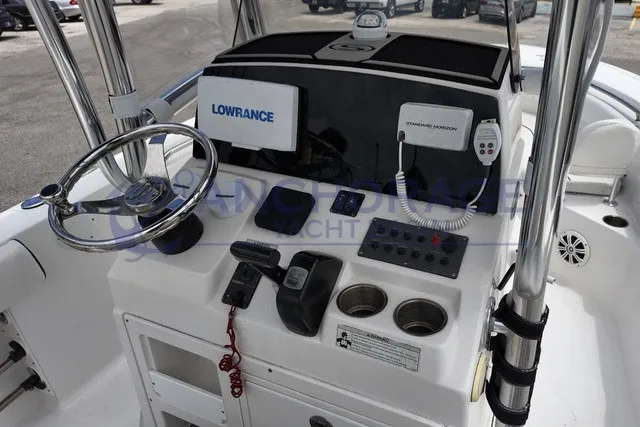 Slide: The Image of The image shows the helm of a 2013 Sportsman Heritage 211 Center Console boat. - 5